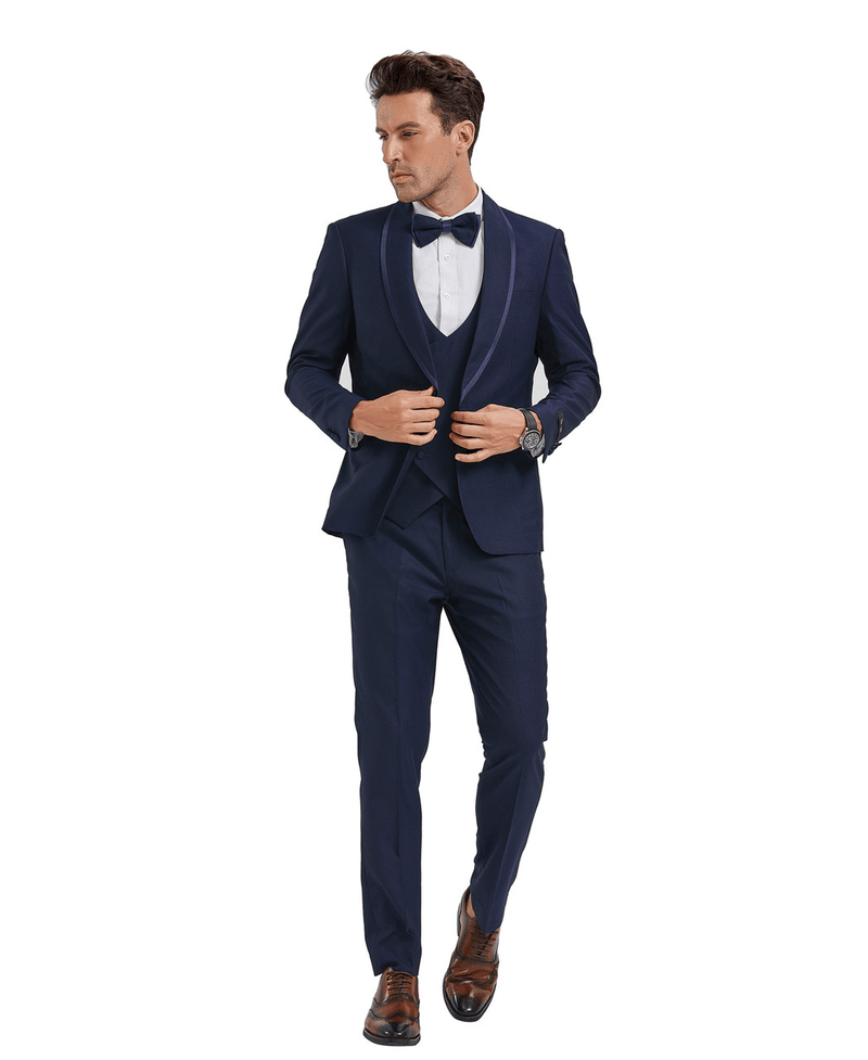 A man wearing a 3-piece classic Birdseye Textured suit. Color Blue. Blue Bowtie included. Jacket, Vest and Pants all match. Solid Colored, Textured. Shawl Lapel Collar Jacket